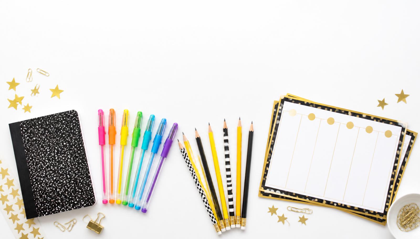 A magnetic weekly planner on a bright desk surrounded by markers